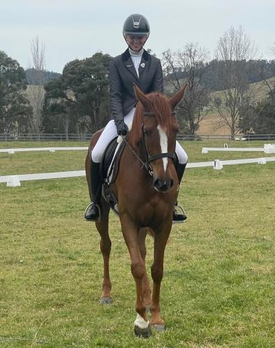 Emerson Serl on her young horse, Oakdale Pastoral Platinum